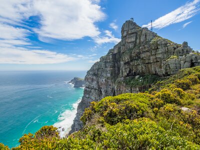 Scenic view on Cape Point with lighthouse, ocean and dramatic sky, Cape Town, South Africa